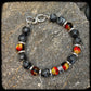 Bracelet MAGMA Perles 10mm larvikite. Fermoir argent 925. Motif DONUT